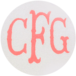 round white rug with large monogram letters in coral