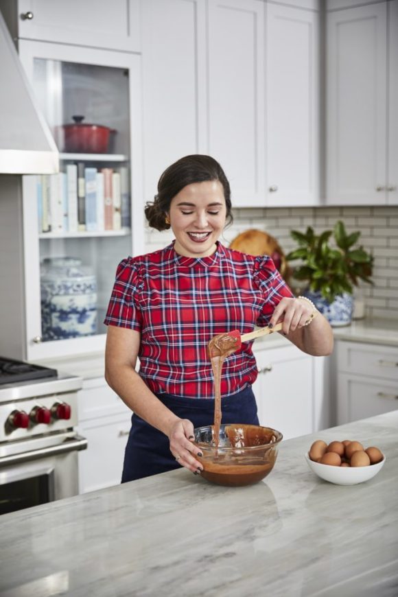 lady in plaid shirt in kitchen mixing brownie batter