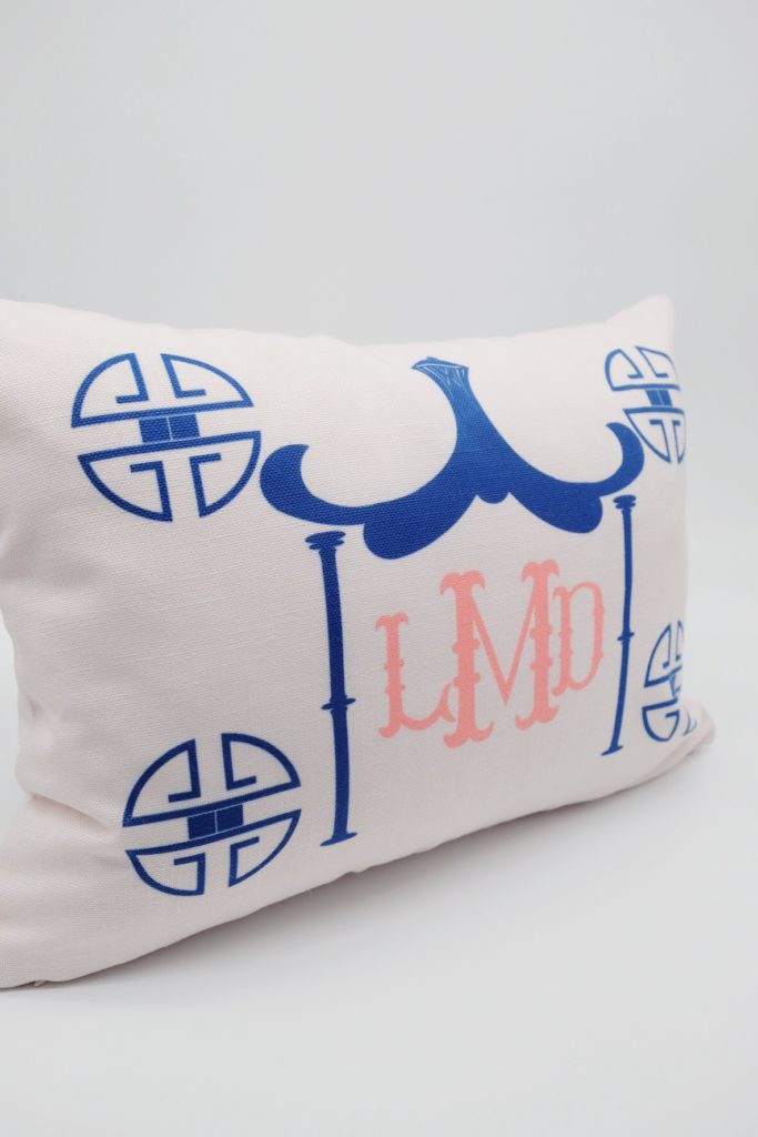 white pillow with pagoda design and monogram