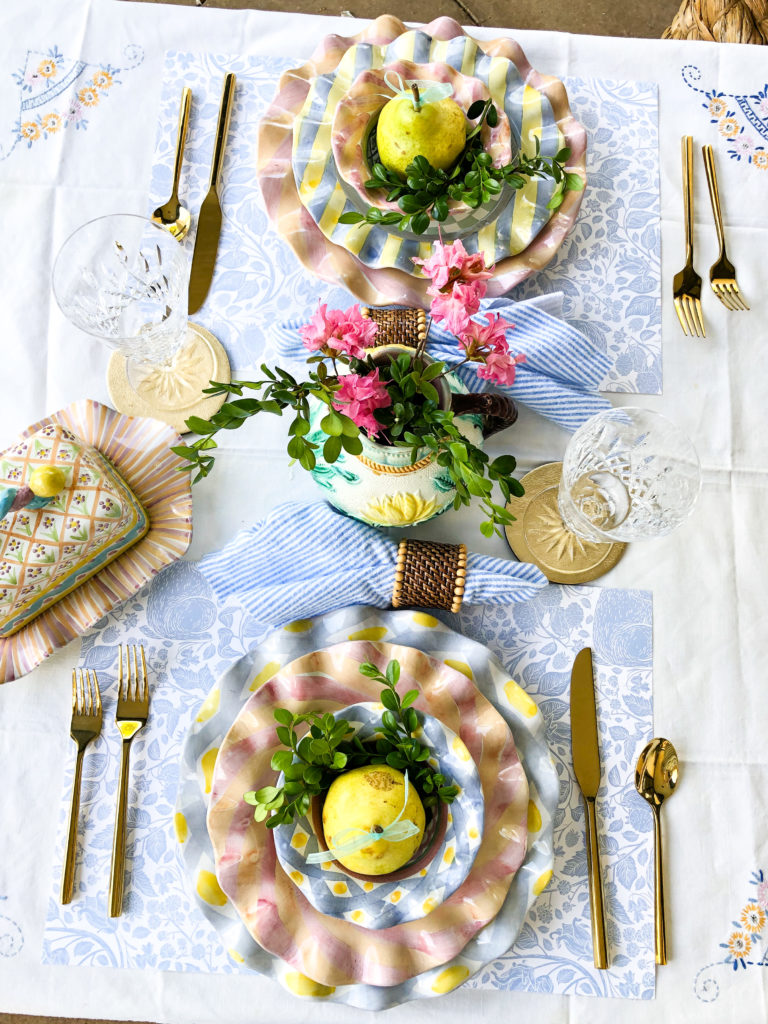 table set for two with ruffled plates and pink flowers