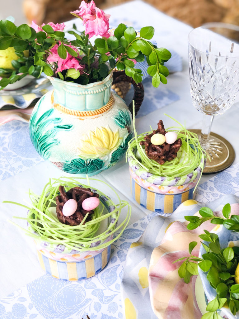 easter table setting with majolica pitcher and flowers with dessert dishes on the side