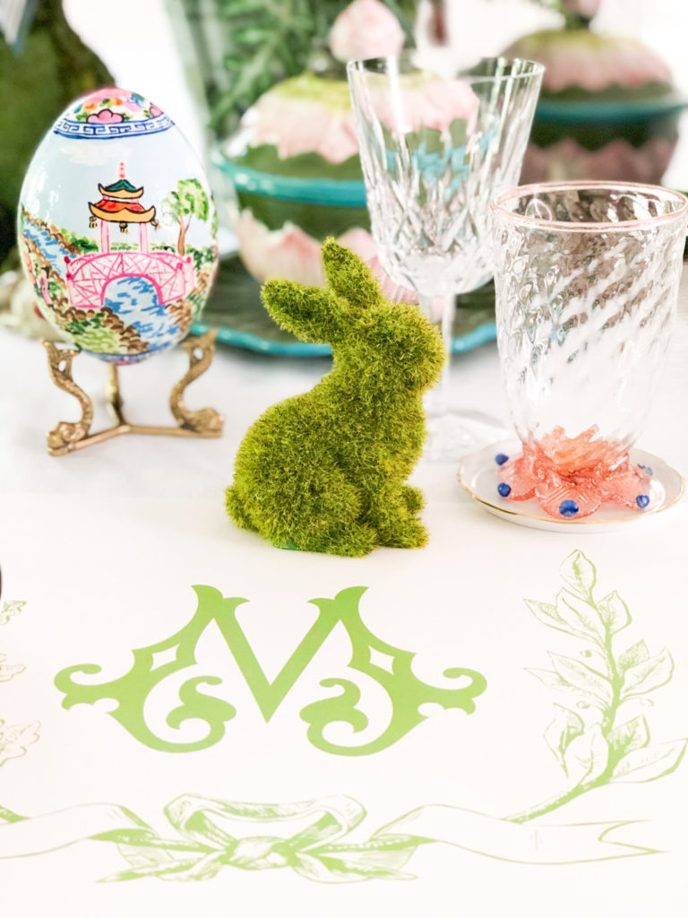 monogrammed placemat with green letter m and laurel leaves and moss bunny