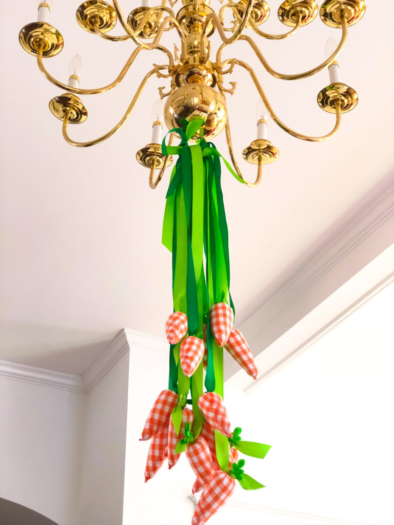 gingham fabric carrots hanging on green ribbon from brass chandelier