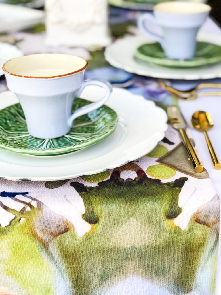 table set with hand painted table runner in green brown lavender white with white green and lavender plates
