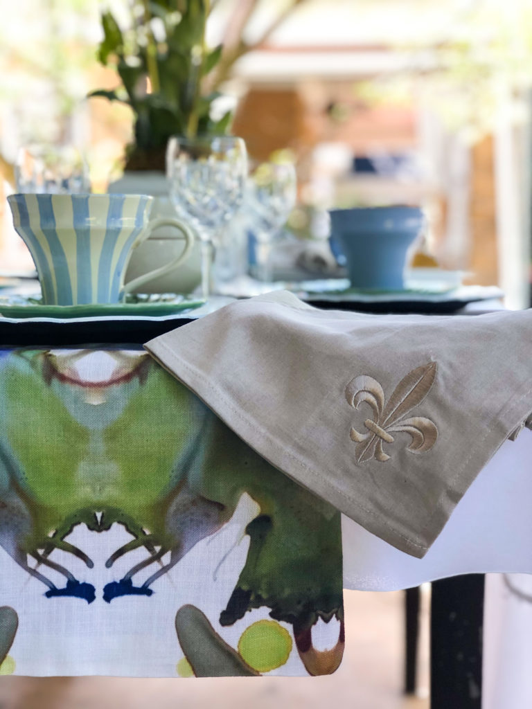 table set with windy oconnor table runner linen napkin with fleur de lis striped mug and solid mug