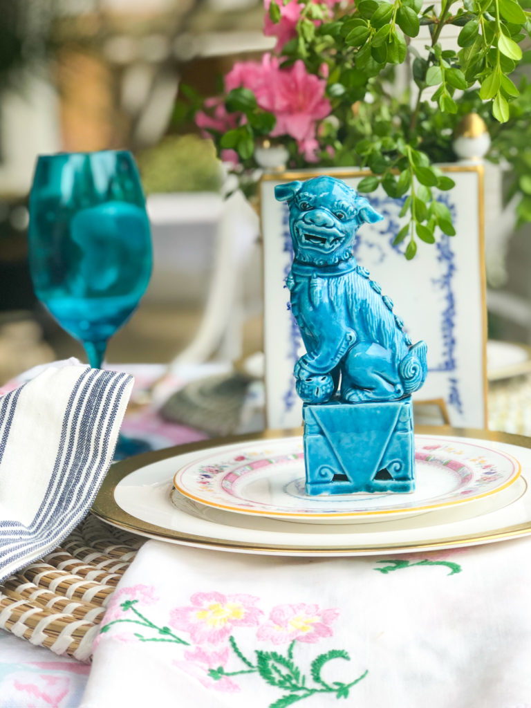 table set with china turquoise foo dog and turquoise vintage glass