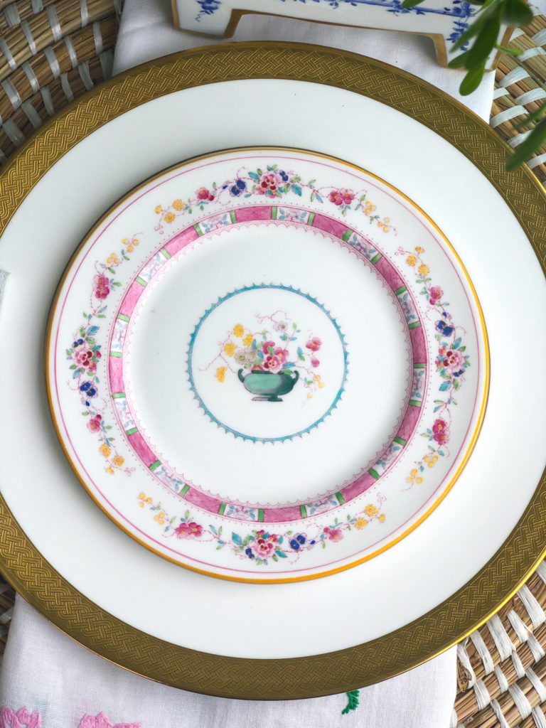 pink and white floral salad plate on top of white plate with gold rim
