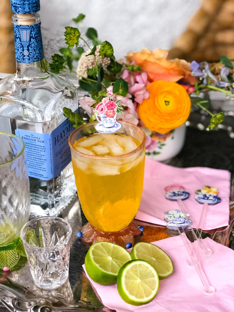 tray with gin orange soda limes flowers and pink napkins