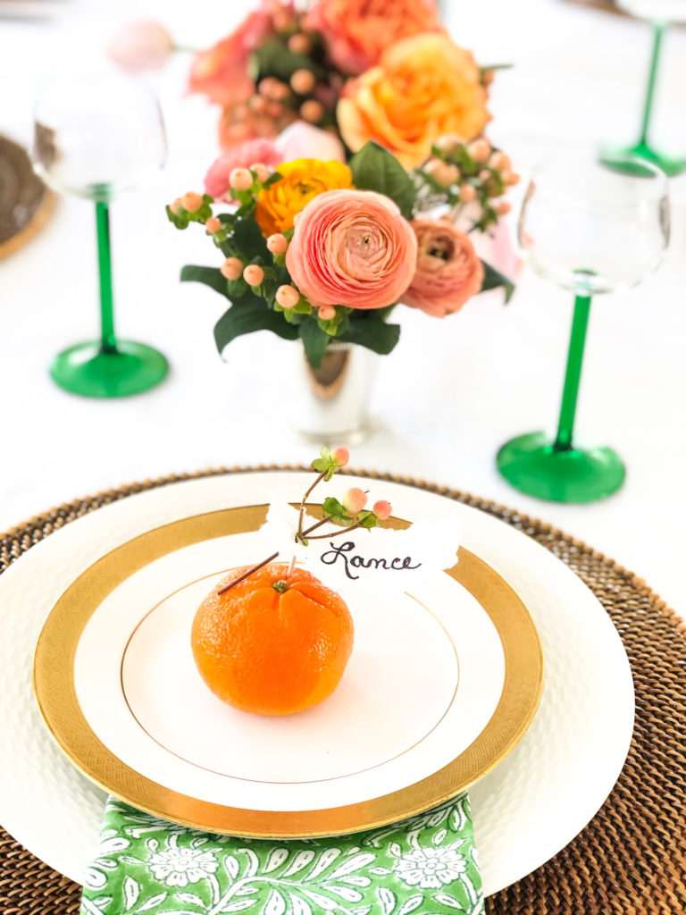 table setting with orange and lance name place card