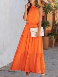 orange maxi dress with white clutch bag