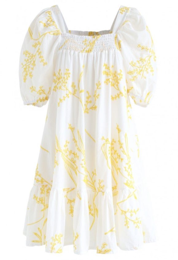white short dress with puffy sleeves and yellow embroidery