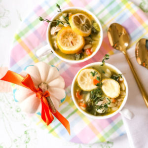 chicken orzo soup in cups on plaid plate