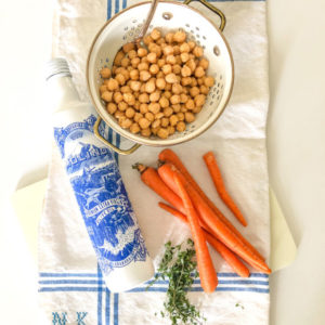 carros on a kitchen towel chickpeas in a bowl olive oil in a blue and white bottle