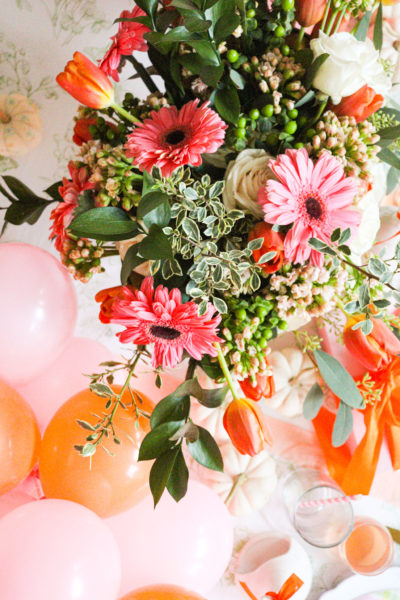 pink and orange flower and balloon centerpiece for halloween girls night party