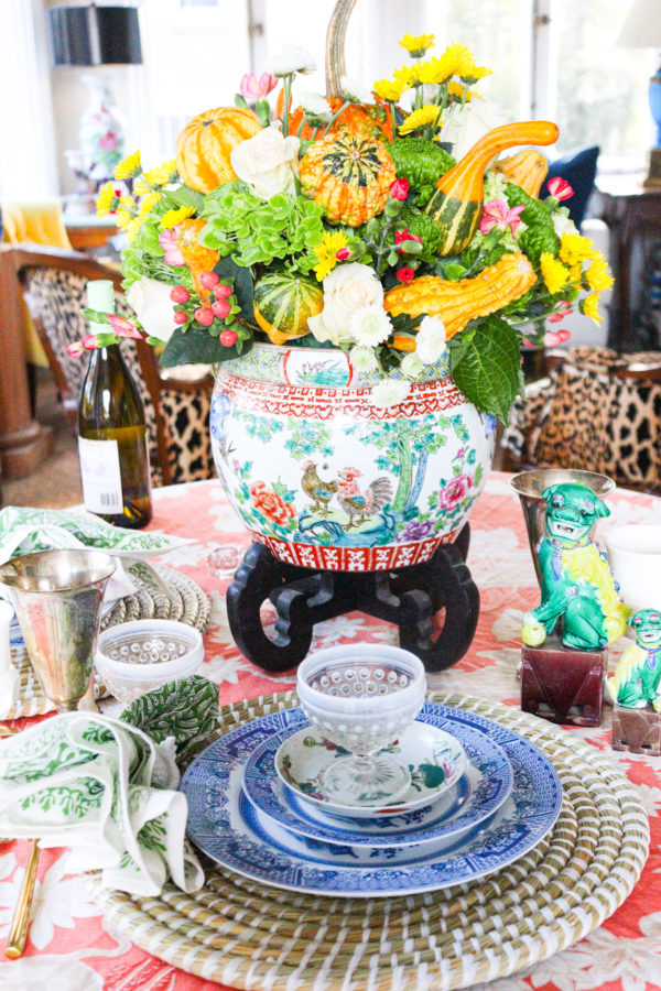 table setting with blue and white china large flower centerpiece with gourds and foo dogs