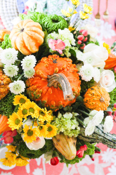 overhead photo of fall floral arrangement with flowers and pumpkins