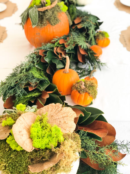 table runner made of live greenery and potted pumpkins
