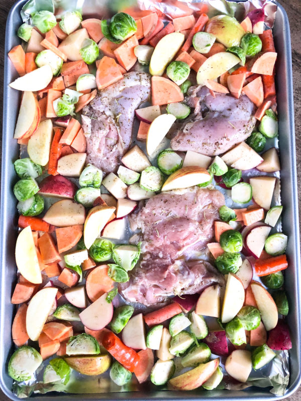 sheet pan with chicken and chopped fall vegetables