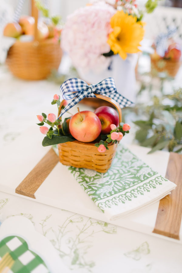 mini picnic basket filled with mini apples and greenery