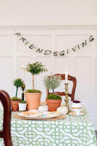 friendsgiving banner on wall with table set in front of it