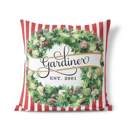 christmas pillow with red and white stripes and a wreath on the front with family last name