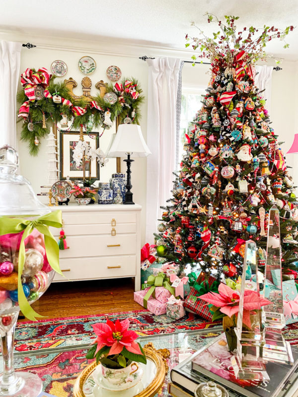 large christmas tree in white room with garland