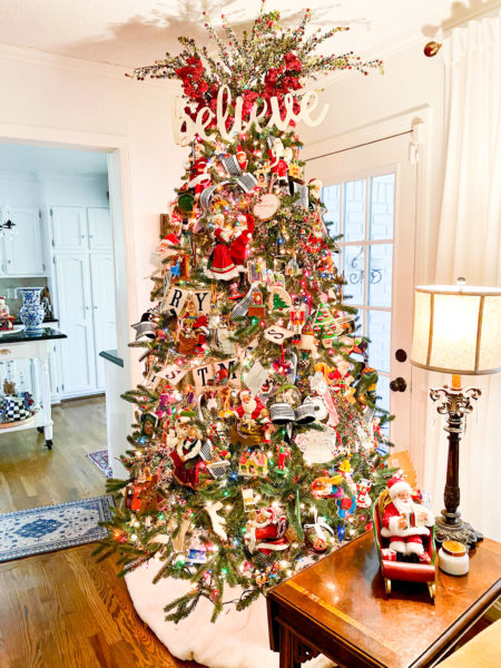 christmas tree with believe sign on top as topper