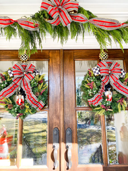 wreaths and garlands with plaid ribbons on double doors