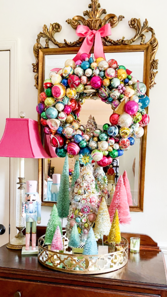 pink ornament wreath with pink bow on mirror