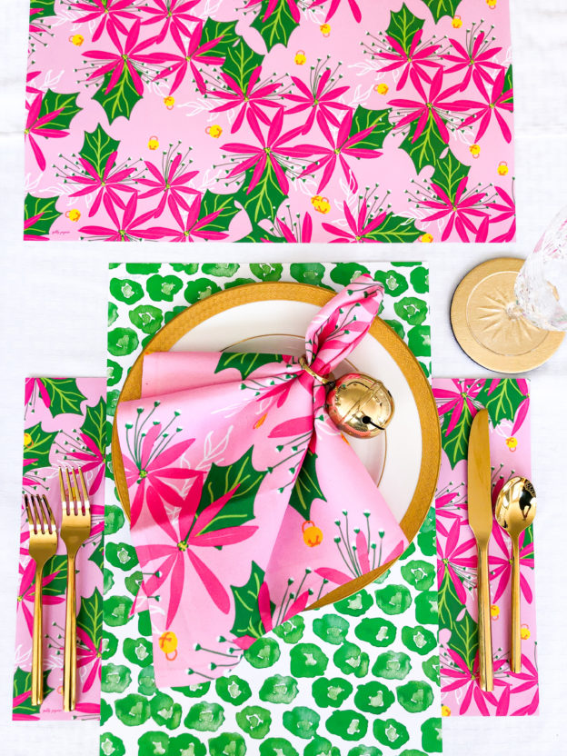 pink and green poinsettia and jingle bell christmas napkins and placemats with green leopard print