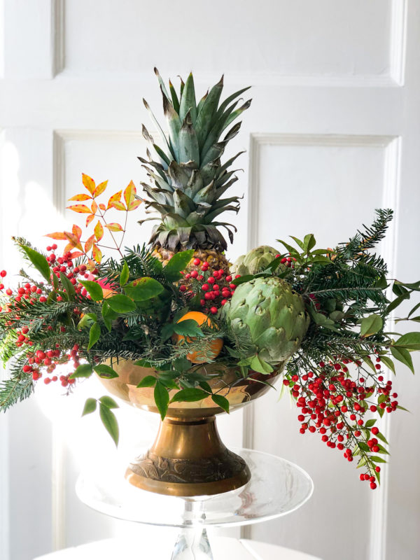 pineapple christmas arrangement with greenery and berries