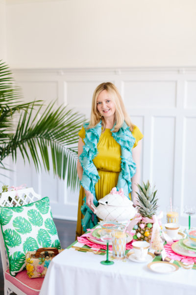 lady at pink and green christmas brunch table