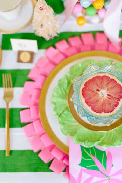 place setting for pink and green christmas brunch with grapefruit