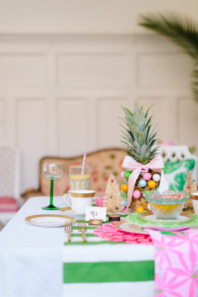 pink and green christmas bring table set with french settee in background