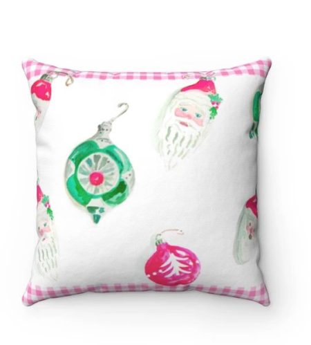 white pillow with pink and green christmas ornaments and santa