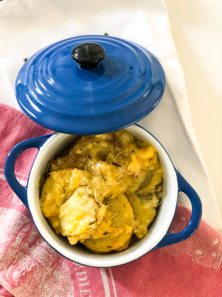 au gratin potatoes on red cloth with blue pot