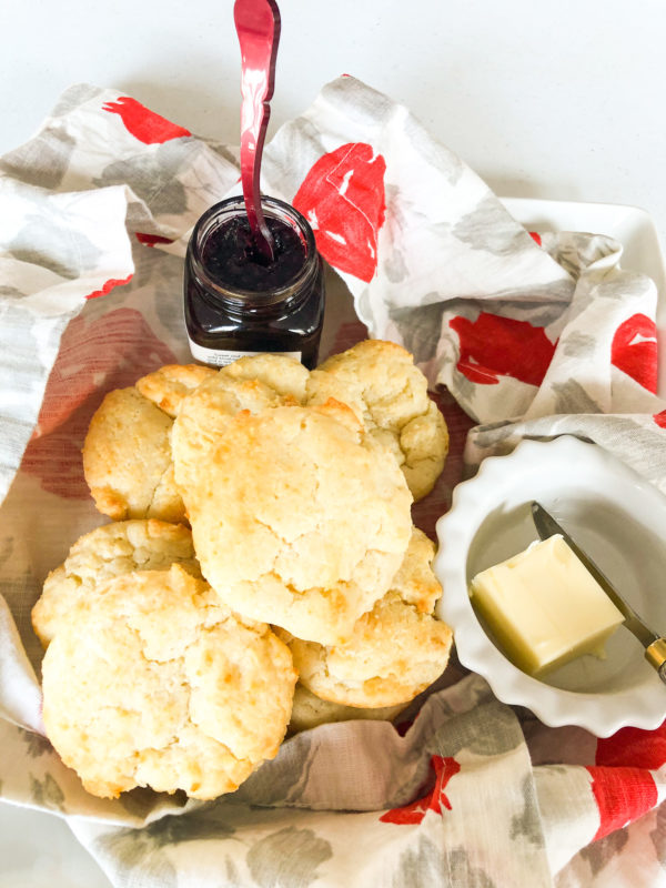 happy biscuits with butter and jelly on a cloth napkin