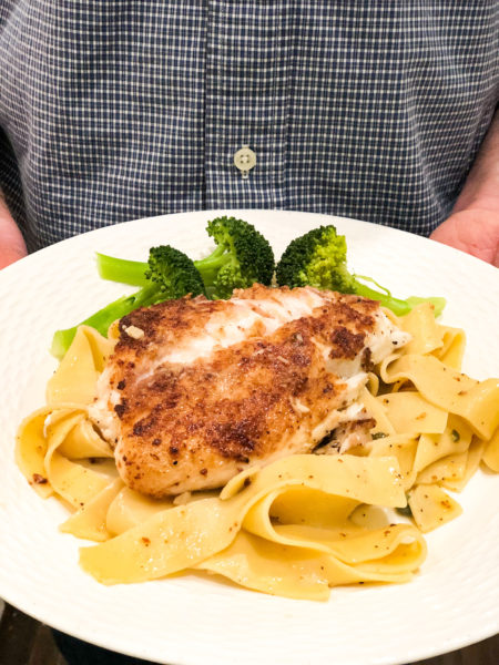 snapper piccata on white plate with egg noodles and broccoli