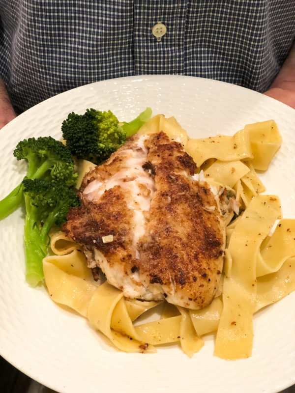 snapper piccata on whote plate with broccoli side