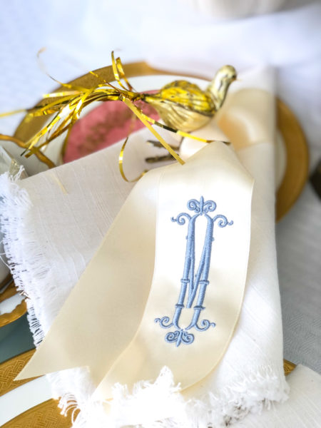 winter white table settig with monogrammed ribbon blue m