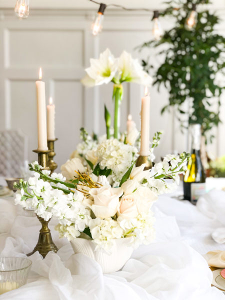 wintry white table setting with flowers candles and tree