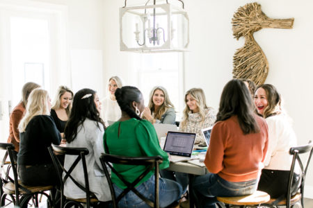 female business meeting around a table with seahorse on wall