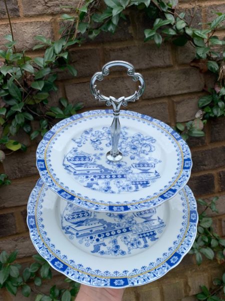 tiered stand with blue and white plates and silver center