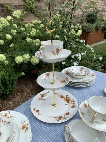 tiered stand on table with other teacups and saucers