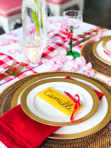 place setting with white plates gold rim and lasagna pasta place card