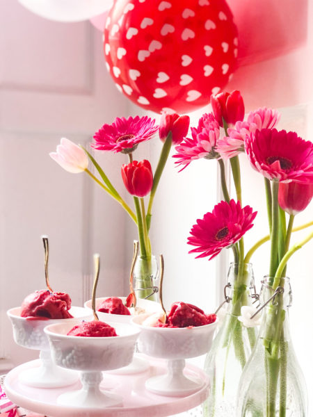 gelato served on pink cake stand with flowers and balloons for valentines day