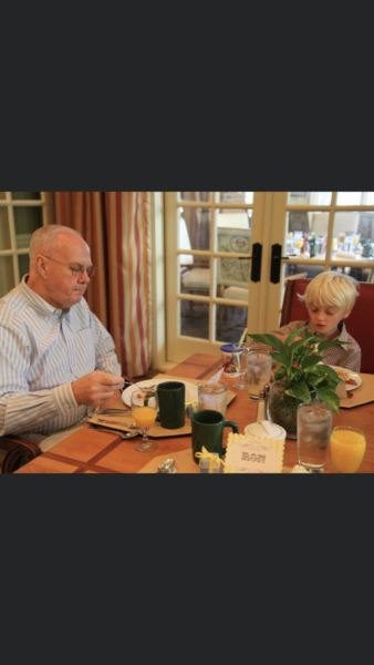 grandfather having a meal with grandson