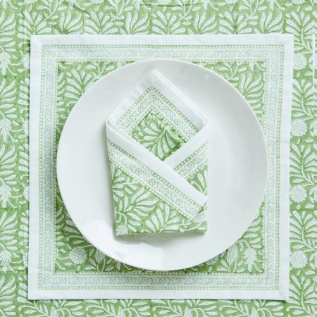 green block print napkin on white plate