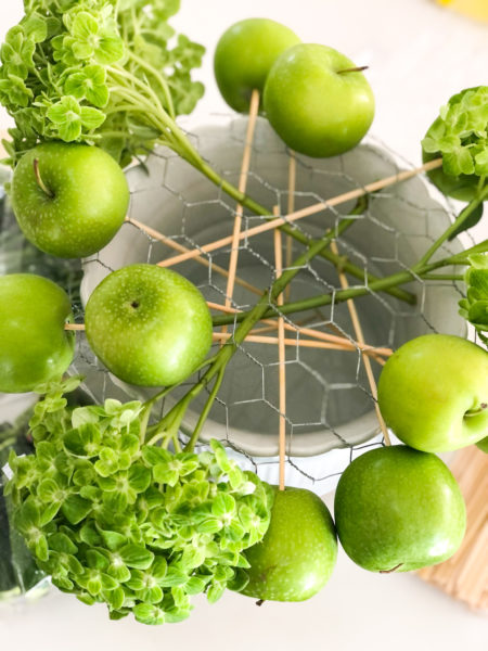 how to arrange an all green floral arrangement for st patricks day chicken wire apples hydrangeas in white planter