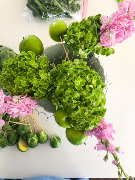 arranging flowers in chickenwire using pink and green blooms